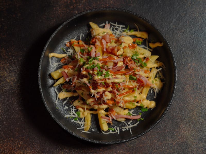 Loaded seasoned fries with cheese and herbs