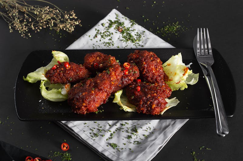 Smoky BBQ dry rub wings with dark crust